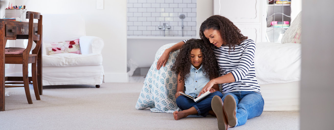 Mom and daughter reading on the floor